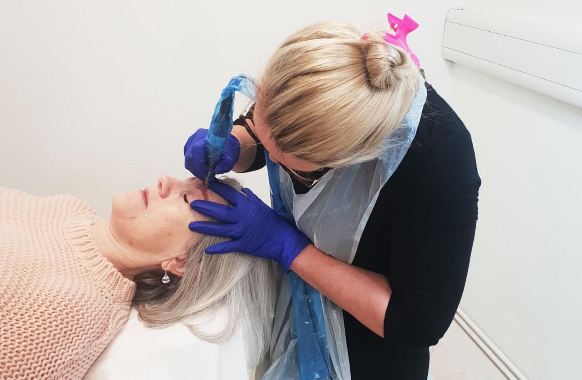 Jo working on a client in the studio